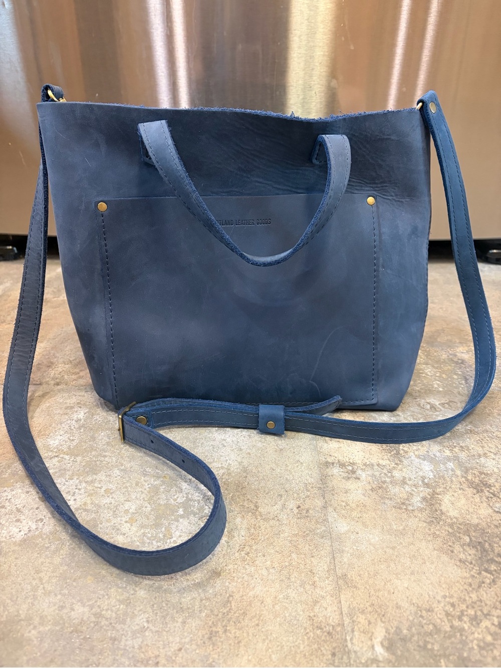 Portland Leather medium crossbody bag deep water with strap extender.
